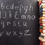 Alphabet on a chalkboard with books
