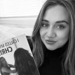 Picture of author Reegyn Maree holding her book.