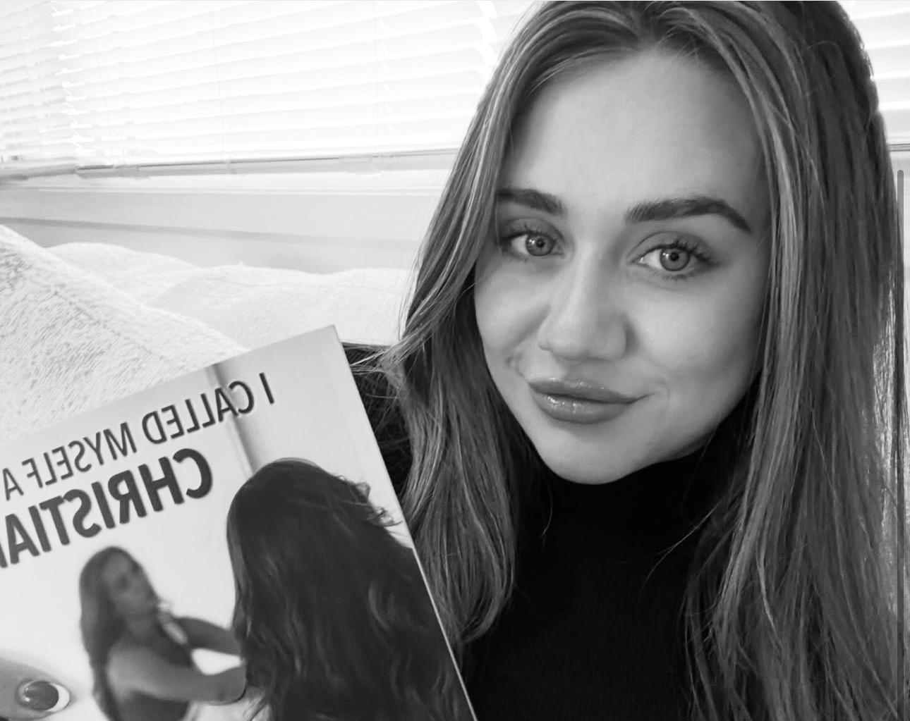 Picture of author Reegyn Maree holding her book.