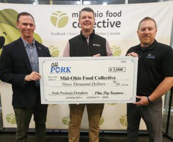Three men hold a large ceremonial check for $3,000 to Mid-Ohio Food Collective, standing in front of a banner.