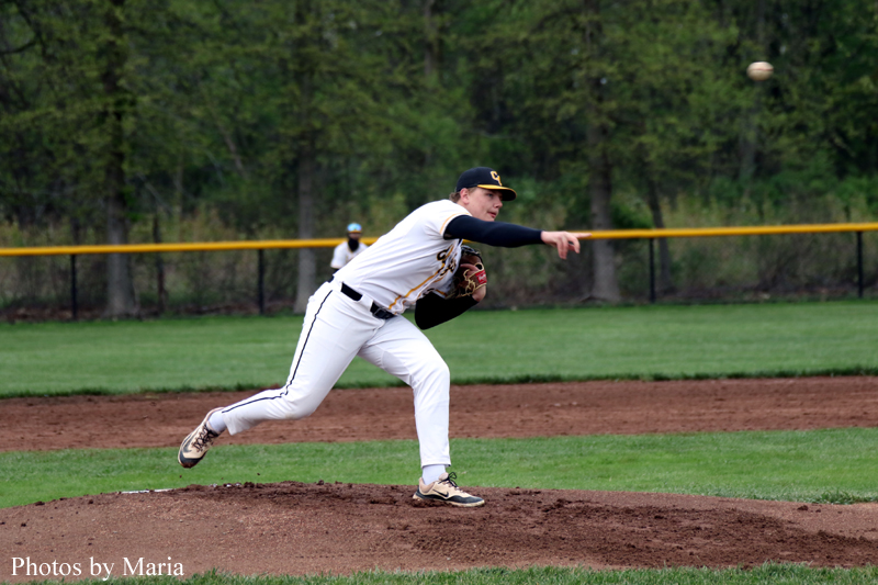Baseball pitcher delivering a pitch from the mound during a game.