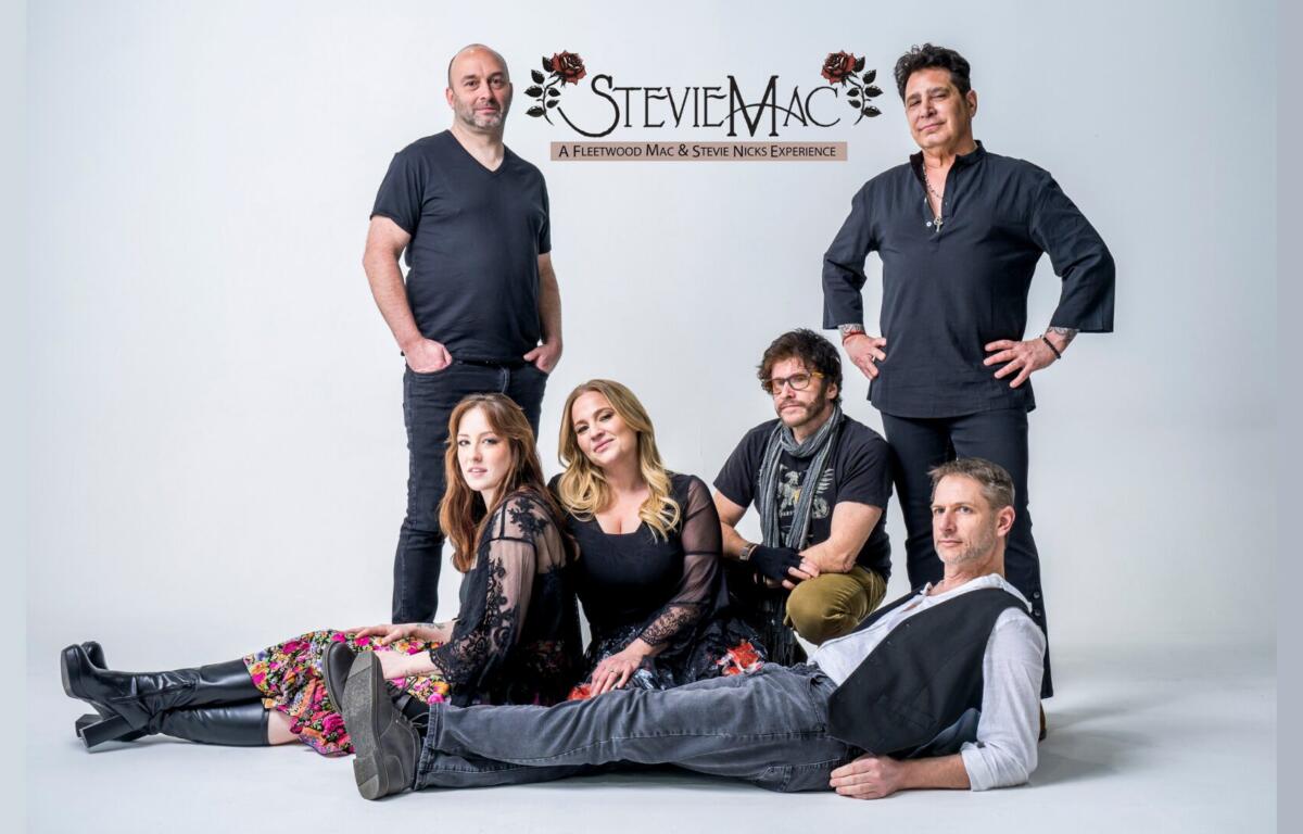 Group portrait of six people posing in a studio with a light backdrop; a StevieMac logo appears above them as a Fleetwood Mac & Stevie Nicks tribute act promo image.