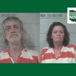 Two side-by-side mugshots: man with long gray hair and beard on the left, woman with dark hair on the right, both in orange-and-white striped jail uniforms against a gray cinder-block wall; timestamp overlays and Crawford County Now logo in corner.