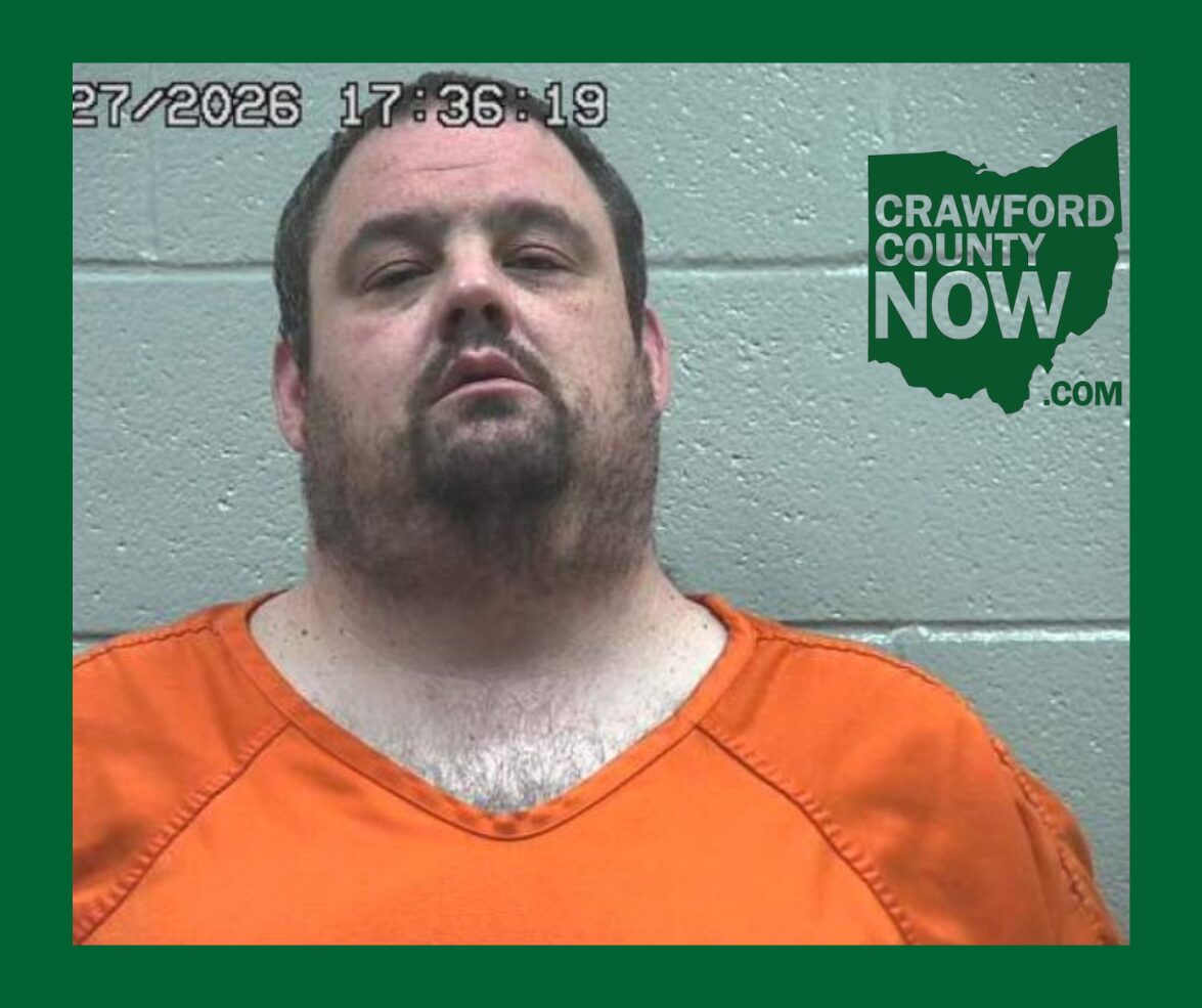 Mugshot of a man in an orange jumpsuit against a gray cinder block wall, with a timestamp in the top-left and Crawford County Now logo on the right.