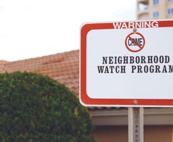 Warning sign for Neighborhood Watch Program, indicating crime prevention in the area