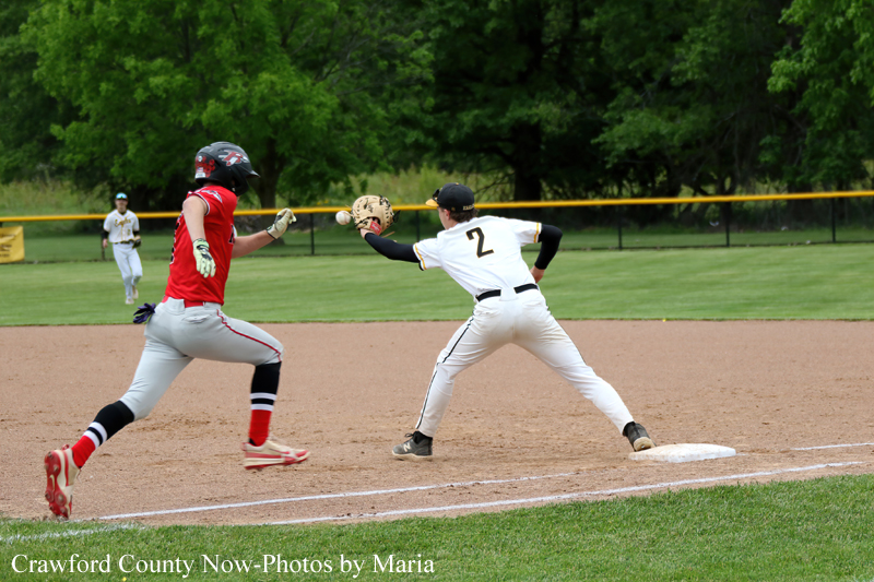 Baseball action: a white-uniform fielder tags out a runner in red near second base on the dirt infield