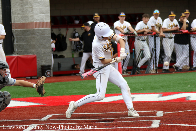 Baseball batter in white uniform with a pink bat swings at a pitch near home plate as the catcher extends his glove.