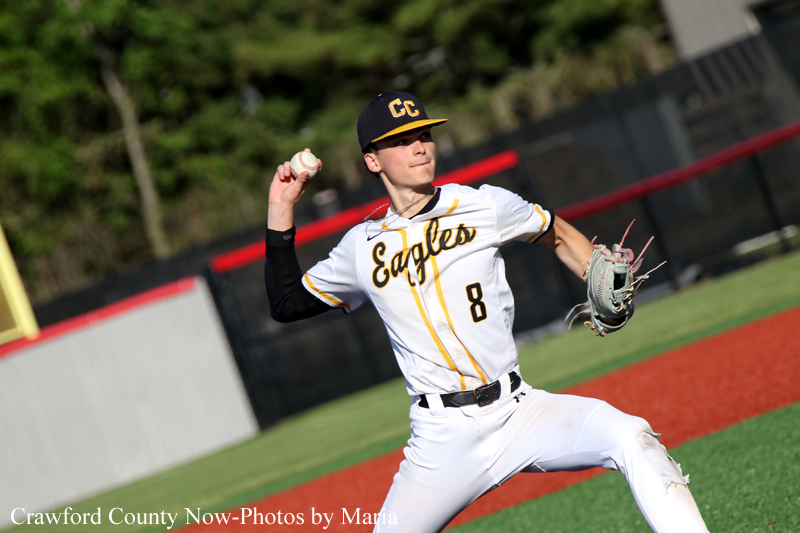 Right-handed baseball pitcher in a white Eagles uniform (number 8) winding up to throw a pitch on a baseball field.