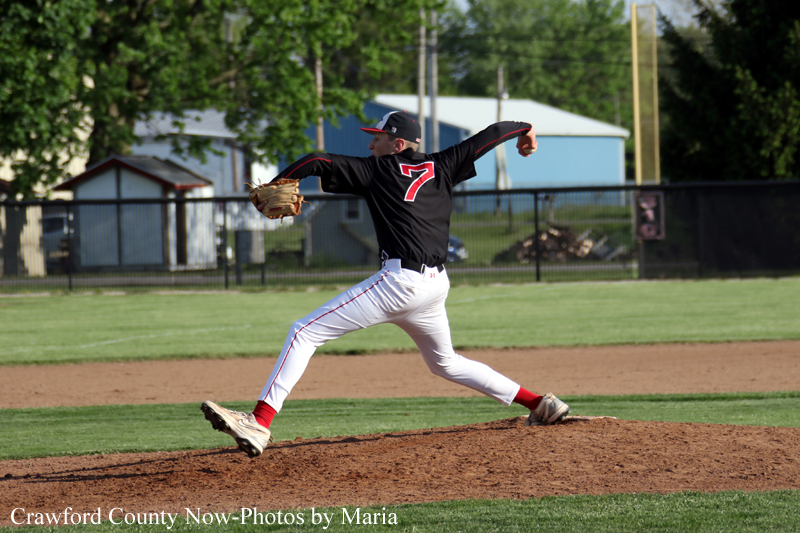 Right-handed baseball pitcher in a black jersey number 7, mid-pitch on the mound during a game.