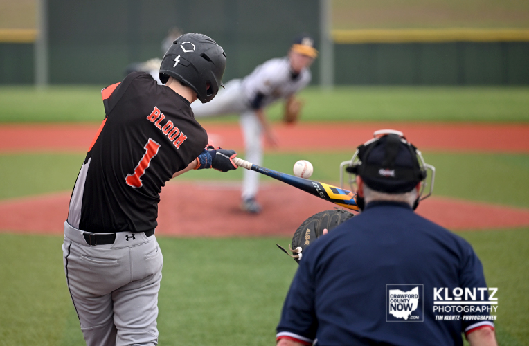 Baseball batter wearing number 1 swings at a pitch while the pitcher and catcher watch on the field.