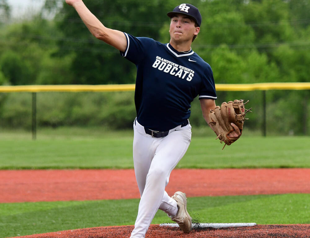 Baseball pitcher in a navy Bobcats uniform delivering a pitch from the mound