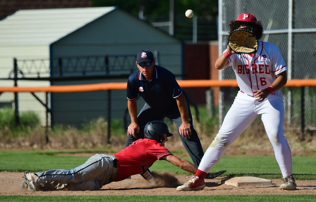 Baseball scene: a white-uniform fielder with glove near a sliding baserunner in red aiming for the base as a ball sails overhead.