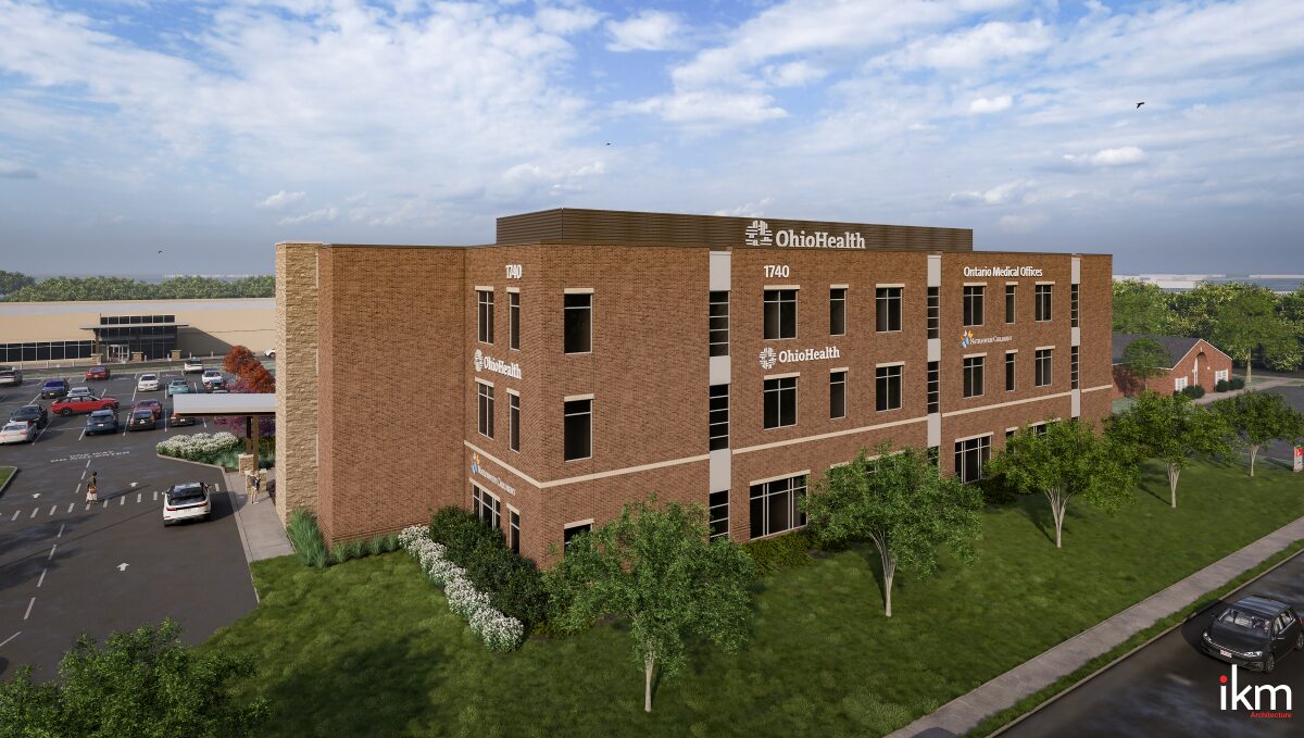 Three-story brick OhioHealth medical office building with parking lot and landscaped lawn, viewed from the grass.