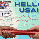 Map of the United States with a bold 'Hello USA!' title, a Relay badge, and two hands passing a red scroll/Constitution over the map.
