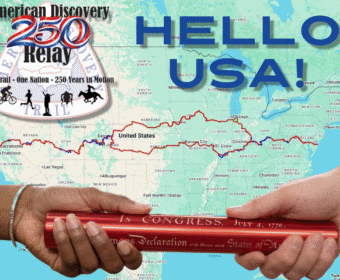 Map of the United States with a bold 'Hello USA!' title, a Relay badge, and two hands passing a red scroll/Constitution over the map.