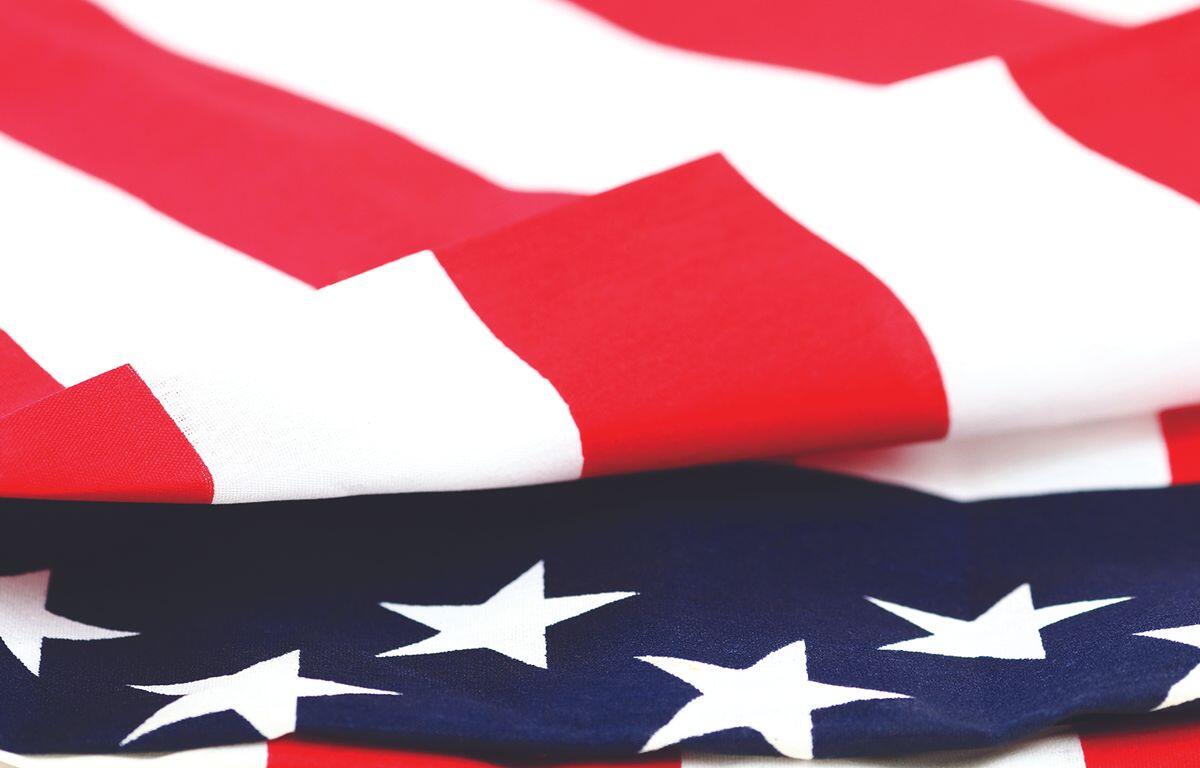 Close-up of the American flag, showing red stripes and white stars on a blue field.