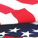 Close-up of the American flag, showing red stripes and white stars on a blue field.