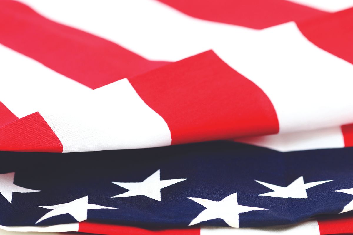 Close-up of the American flag, showing red stripes and white stars on a blue field.