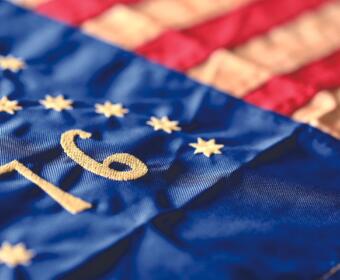 Close-up of blue EU flag fabric with yellow stars and the embroidered number 10.