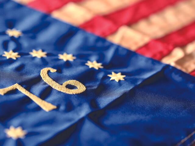 Close-up of blue EU flag fabric with yellow stars and the embroidered number 10.