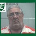 Mugshot of a middle-aged man with gray hair and glasses in orange-and-white jail clothes, against a gray wall; Crawford County Now logo in the corner.