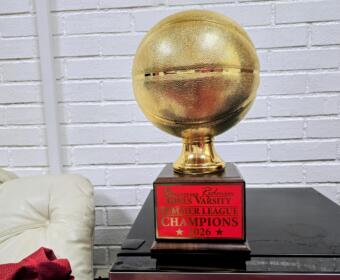 Gold basketball trophy on a wooden base with a red plaque that reads 'Bruins Redmen Girls Varsity Summer League Champions 2026'.