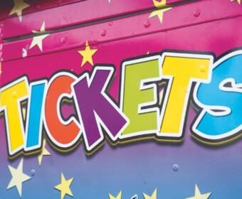 Colorful graffiti-style lettering that spells 'TICKETS' on a pink-to-blue backdrop with yellow stars.