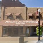 Storefront of Furner's Floor Covering, brick building with a brown awning and service text visible on it at street level