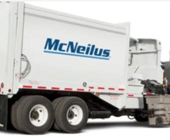 White McNeilus concrete mixer truck with a large rotating drum, viewed from the side.