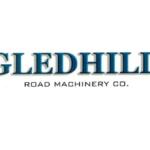 Gledhill Road Machinery Co. logo with blue shield icons on each side of the name