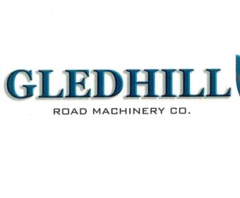 Gledhill Road Machinery Co. logo with blue shield icons on each side of the name